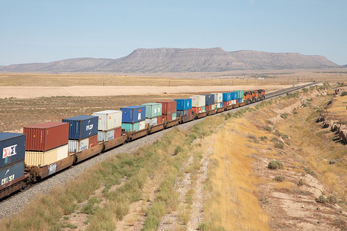 A BNSF intermodal train with stacks of containers A BNSF intermodal train with stacks of containers